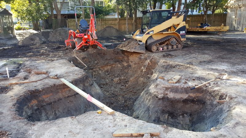 A large hole is being dug for construction.