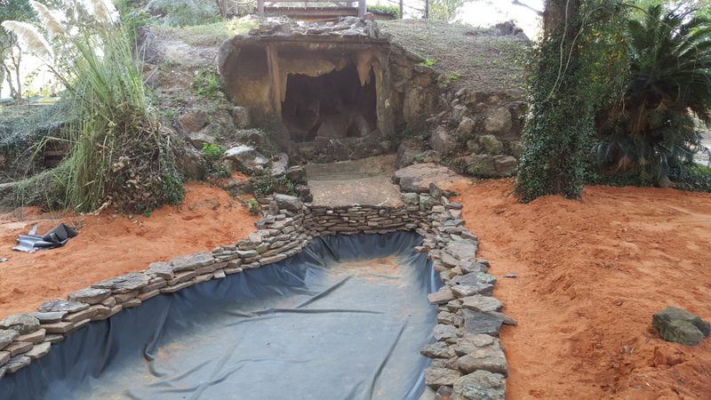 A pool in the middle of an area with rocks.