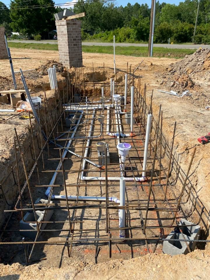 A construction site with pipes and concrete
