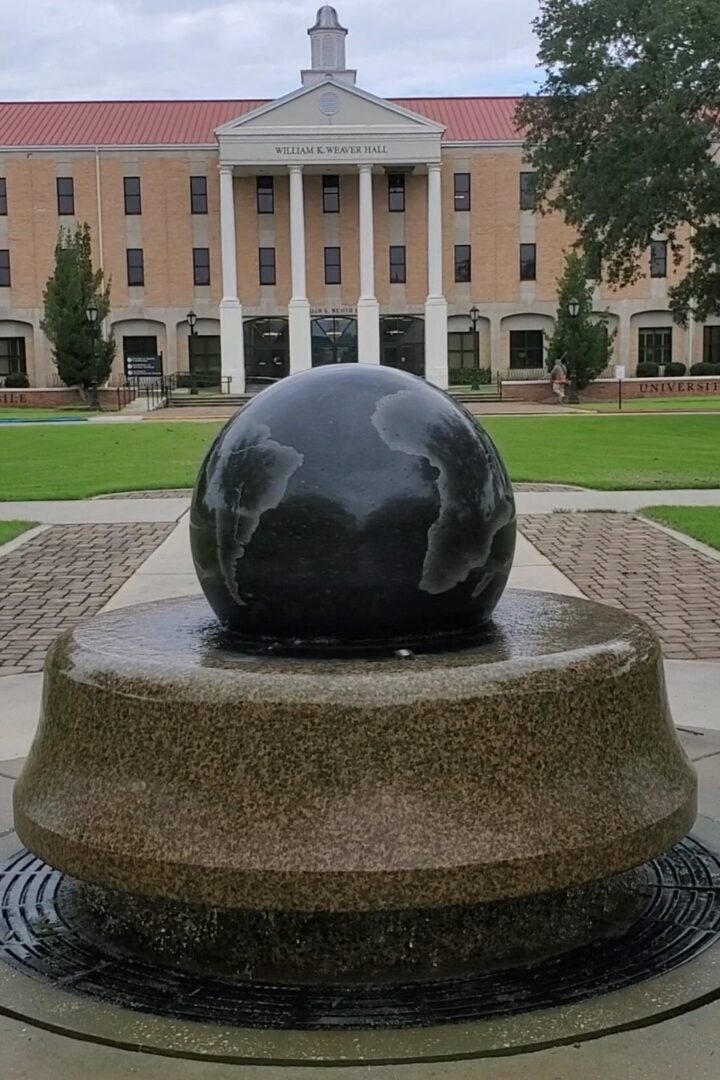 A fountain with a globe on top of it.