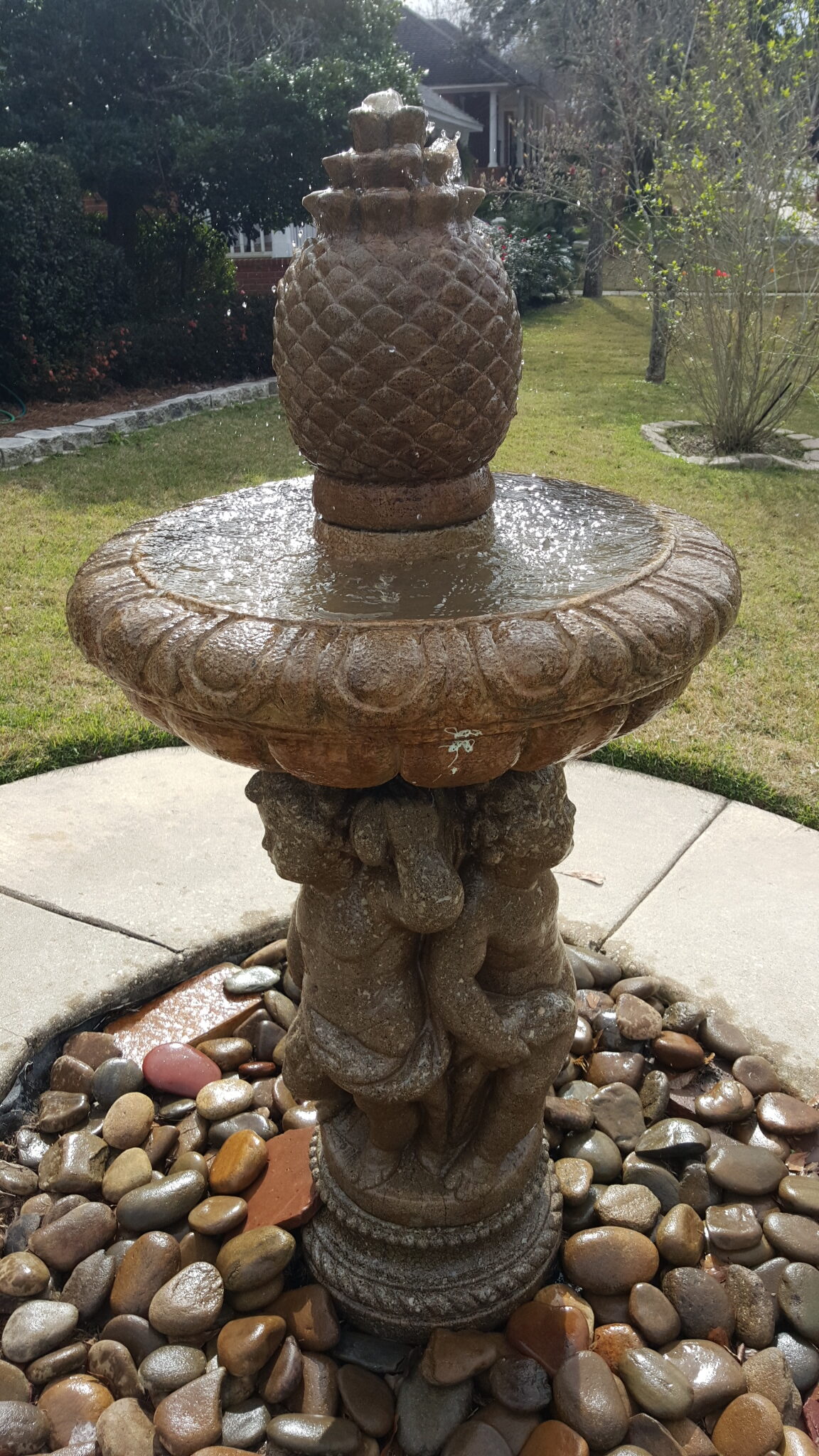 A fountain with a pineapple on top of it.