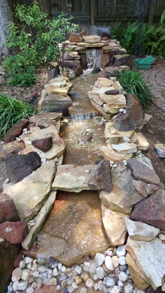 A small stream of water flowing through rocks.