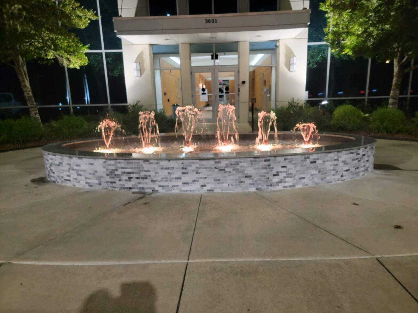 A fountain with lights in the middle of it
