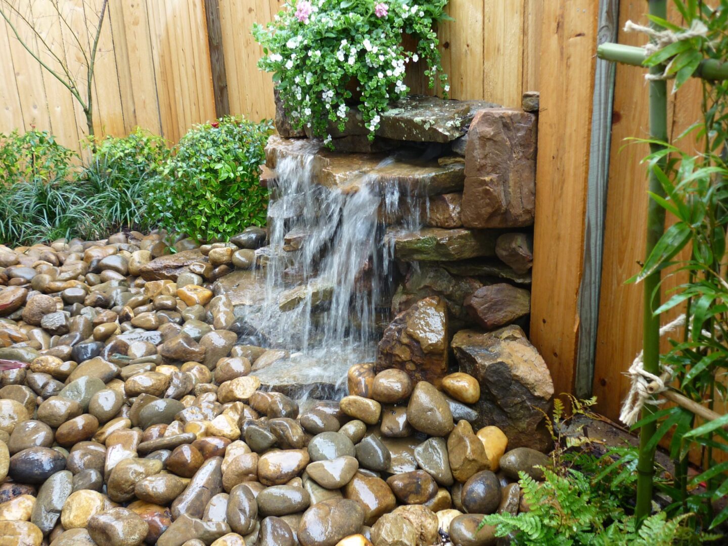 A waterfall is shown in the middle of a garden.